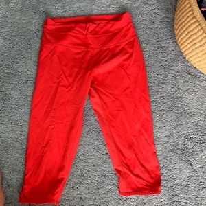 Bright red Lululemon leggings with cutouts